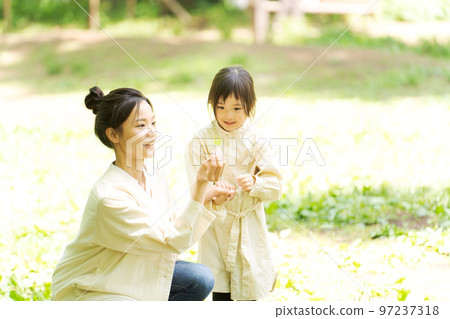 Mom and girl playing in nature 97237318