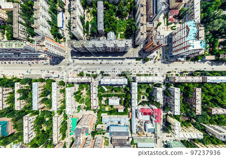 Aerial city view with crossroads and roads, houses, buildings, parks and parking lots. Sunny summer panoramic image 97237936