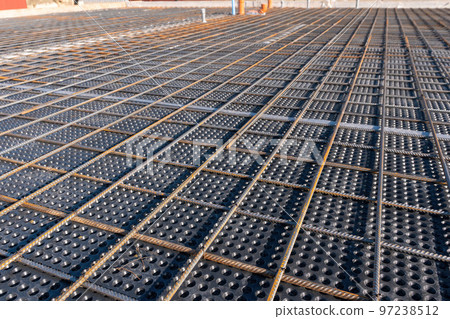 Close up view of reinforcement of concrete. Geometric alignment of Rebars on construction site. Reinforcements steel bars stack. Close up view of reinforcement of concrete. Geometric alignment of Rebars on construction site. Reinforcements steel bars stack. 97238512