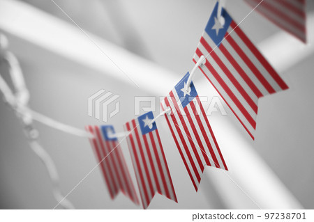 A garland of Liberia national flags on an abstract blurred background A garland of Liberia national flags on an abstract blurred background 97238701