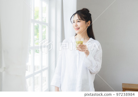 A woman relaxing at the window 97238984