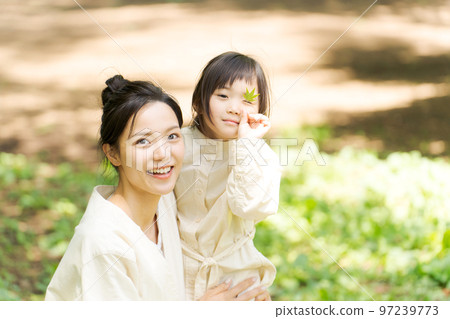 mom and child playing in the park 97239773