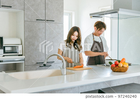 Young Asian couple cooking together in the kitchen at home (housework men) 97240240