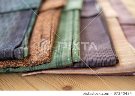 Komon and pongee kimonos lined up on the floor Komon and pongee kimonos lined up on the floor 97240484