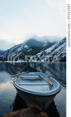 Mountain lake in the forest with mirror water Mountain lake in the forest with mirror water 97241087