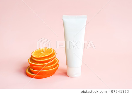 White squeeze bottle cosmetic tube pack and orange slices on pink background. Mockup. Daily cream, gel, skin care, sunscreen, moisturizer, toothpaste with vitamin c. Front view, blank tube template White squeeze bottle cosmetic tube pack and orange slices on pink background. Mockup. Daily cream, gel, skin care, sunscreen, moisturizer, toothpaste with vitamin c. Front view, blank tube template 97241553