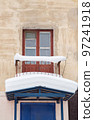 A small balcony covered with snow over a canopy with a large white snowdrift 97241918