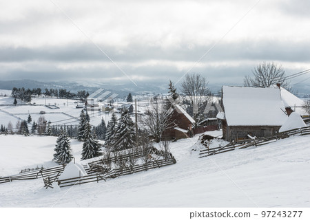 Alpine village in winter in Transylvania Alpine village in winter in Transylvania 97243277