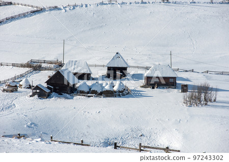 Alpine village in winter in Transylvania 97243302