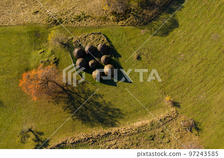 Group of autumn haystacks in a meadow, aerial view 97243585