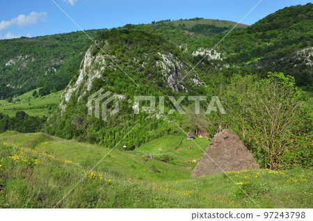 Mountain village with isolated wooden houses Mountain village with isolated wooden houses 97243798