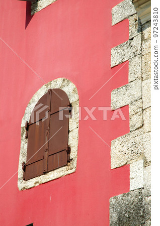 Old window on a red wall 97243810