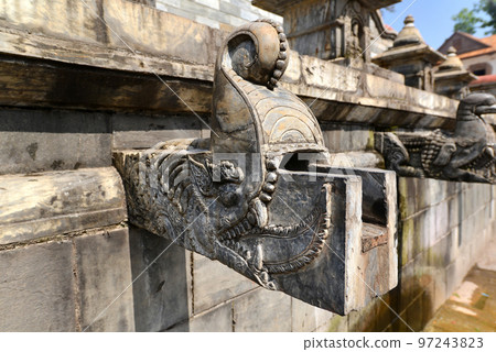 Carved stone public fountain in Pashupatinath, Nepal Carved stone public fountain in Pashupatinath, Nepal 97243823