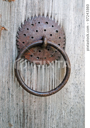 Closeup image of old door with circle iron door-handle 97243860