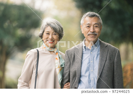 Classy senior couple smiling outdoors 97244025