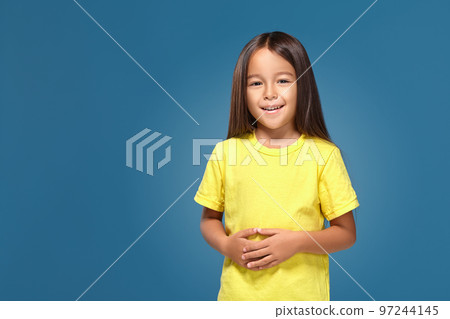 Little girl in yellow t-shirt is smiling Little girl in yellow t-shirt is smiling 97244145