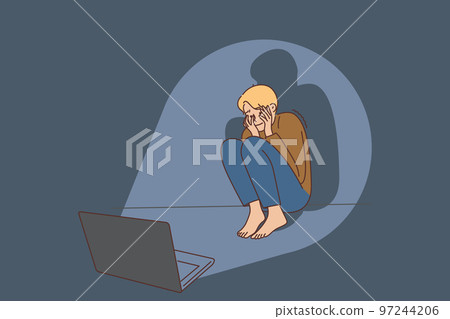 Scared boy afraid of movie on laptop 97244206