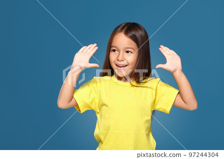 Little girl in raising her hands up 97244304