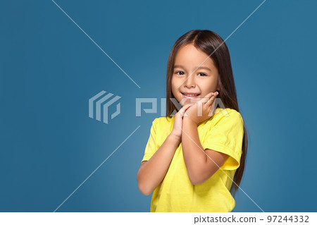 Close up portrait of cute joyful pretty little girl with excellent skin and beaming smile 97244332