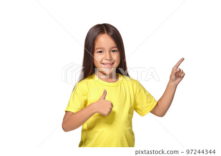 Girl in yellow t-shirt shows her hands with thumbs Girl in yellow t-shirt shows her hands with thumbs 97244344