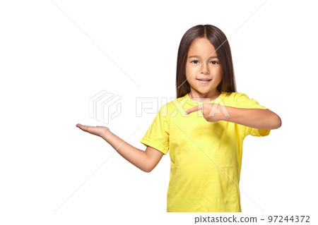 Little girl in yellow t-shirt holding her hand out 97244372