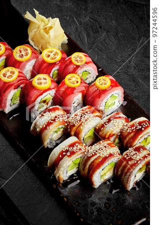 Sushi rolls with eel, tuna, cream cheese, avocado, cucumber, unagi sauce 97244596
