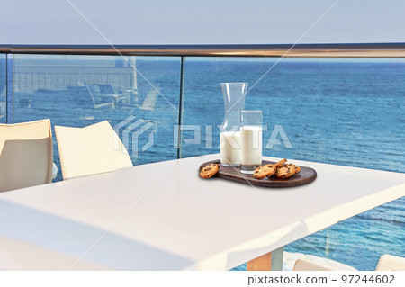 Table for two served with a breakfast on outdoor hotel balcony with a sea view. Table for two served with a breakfast on outdoor hotel balcony with a sea view. 97244602
