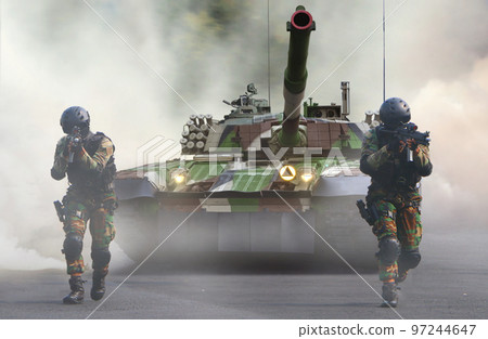 Military special forces and tank moving on the street under smoke screen behind enemy line Military special forces and tank moving on the street under smoke screen behind enemy line 97244647