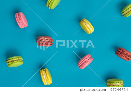Colored macaron or macaroon, sweet meringue-based confection on blue background. Close-up, copy space. 97244724