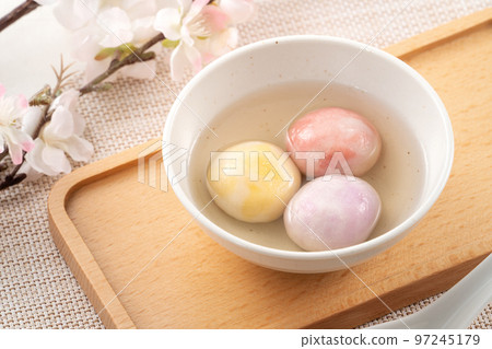 Colored glaze style big tangyuan with cherry blossom flower and syrup soup. Colored glaze style big tangyuan with cherry blossom flower and syrup soup. 97245179