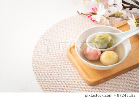 Colored glaze style big tangyuan with cherry blossom flower and syrup soup. 97245182