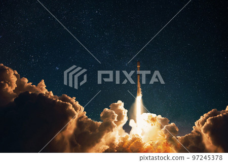 Space rocket successfully takes off into the starry night sky with blast and puffs of smoke. Successful launch and takeoff of a space mission. Space ship concept 97245378