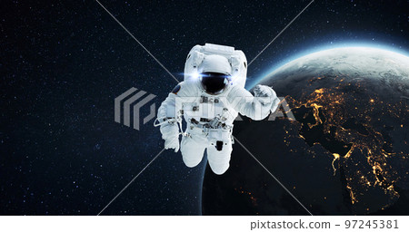 Space man astronaut flying in outer space with amazing night planet earth with city lights. Successful start of space mission and space exploration 97245381