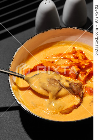 Close-up shot of a delicious cream soup with meat, top view. Close-up shot of a delicious cream soup with meat, top view. 97245402