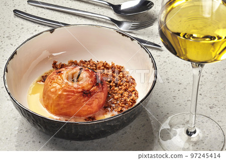 Close-up photo of a tasty baked apple stuffed with honey and nuts. 97245414