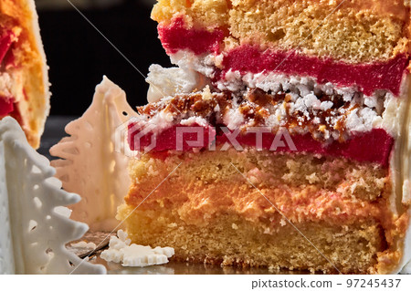 Delicious pink cream cake against a black studio background. Delicious pink cream cake against a black studio background. 97245437