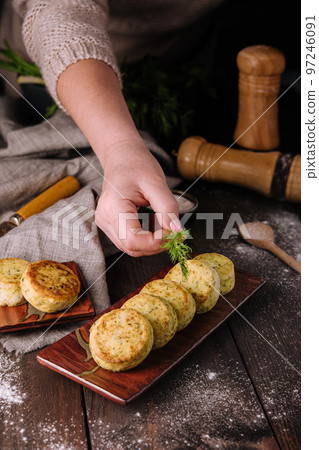 Vegetable zucchini pancakes with cheese, dill and parsley on a plate 97246091