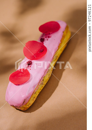bright eclair in pink glaze sprinkled bright eclair in pink glaze sprinkled 97246121