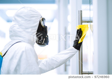 Cleaning and disinfection of office to prevent COVID-19, Man in protective hazmat suit washes office Cleaning and disinfection of office to prevent COVID-19, Man in protective hazmat suit washes office 97246960