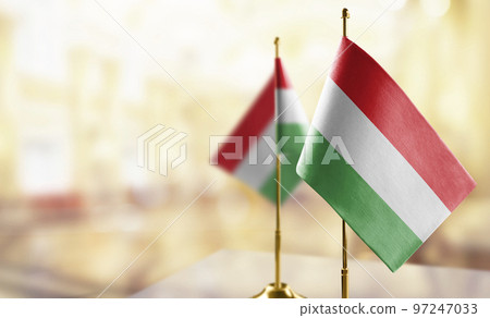Small flags of the Hungary on an abstract blurry background Small flags of the Hungary on an abstract blurry background 97247033