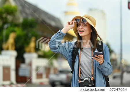Beautiful caucasian woman traveler with backpack on holiday vacation trip in Thailand. Lifestyle travel and technology concept 97247034