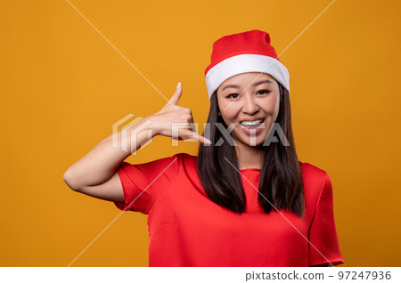 Cute happy young woman in red speaking on air phone Cute happy young woman in red speaking on air phone 97247936