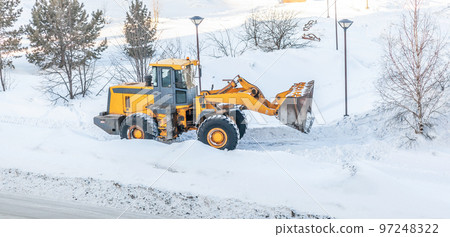 Snow clearing. Tractor clears the way after heavy snowfall. 97248322
