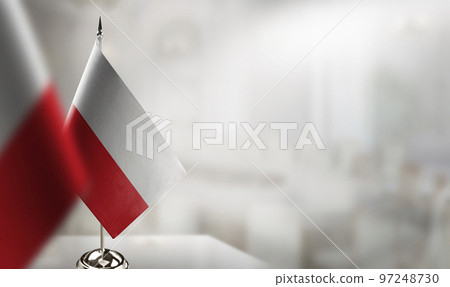 Small flags of the Poland on an abstract blurry background 97248730