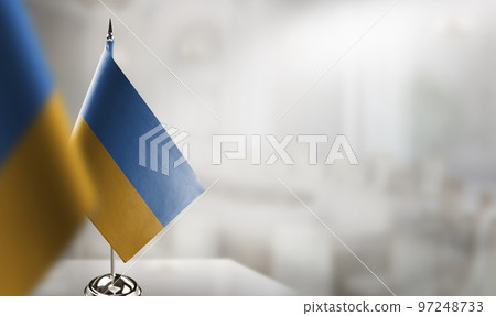 Small flags of the Ukraine on an abstract blurry background 97248733