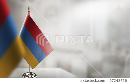 Small flags of the Armenia on an abstract blurry background Small flags of the Armenia on an abstract blurry background 97248756