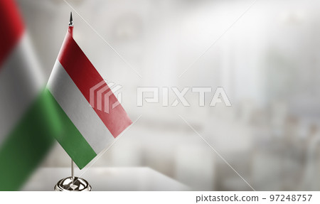 Small flags of the Hungary on an abstract blurry background 97248757