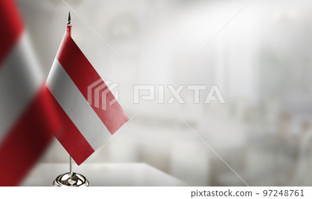Small flags of the Austria on an abstract blurry background 97248761