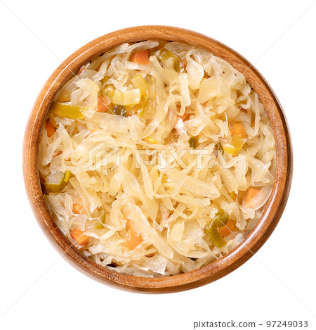 Bavarian style sauerkraut, in a wooden bowl. German sauerkraut, a warm served side dish, made of cut, raw cabbage, fermented by lactic acid bacteria, cooked with carrot cubes, leek slices and beer. Bavarian style sauerkraut, in a wooden bowl. German sauerkraut, a warm served side dish, made of cut, raw cabbage, fermented by lactic acid bacteria, cooked with carrot cubes, leek slices and beer. 97249033