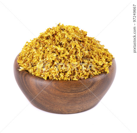 Osmanthus tea in wooden bowl, isolated on white background. Dry flowers of Osmanthus fragrans. 97249667